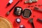 Women`s accessories and background for girls. Women bag, watches, and cosmetics. Red background, styling photography and creative