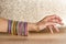Women`s arm with multiple multi-colored bracelets