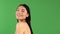 Women`s beauty. Portrait of young smiling asian woman isolated on green background. Asian Caucasian Mixed Race Model