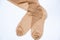 Women`s beige nylon stockings on a white background close up