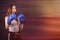 Women`s boxing girl boxer stands in boxing gloves