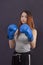 Women`s boxing girl boxer stands in boxing gloves