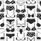 Women`s bras and panties. Black and white decorative background. Seamless pattern with lady`s lingerie