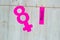 Women`s Day Concept. The symbol of Venus. Pined on the clothespins paper figure eight and the word Mart