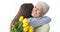 Women`s day. Daughter greeting her mother, giving flowers