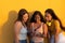 Women`s Diversity, Girl Power, Femininity Concept. Group Of Three Happy Young Women Holding Cellular