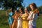 Women`s Equality Day, Girl power, diversity, femininity concept. Group of five happy young women holding Roses flowers on nature