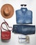 Women& x27;s fashion clothing and accessories. Jeans, denim shirt, sneakers, felt hat, leather bag, sunglasses, layout on a white