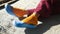 Women`s feet in blue sandals and orange socks in the sun