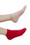 Women`s feet in different socks. Red and pink sock on the legs of a young woman