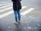 Women`s feet in front of a pedestrian crossing, start something