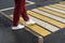 Women`s feet on a pedestrian crossing after the rain