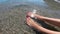 Women`s feet in the sea waves on the beach. Top view of body part. Pedicure foot fingers