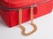Women`s gold chain with female red leather cosmetic bag