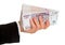Women`s hand holds a large pack of paper Russian money