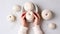 Women\\\'s hands BEAUTIFUL close-up, knitting for a newborn, crochet. top view on soft creamy white background.AI generated