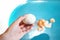 Women`s hands clean a boiled egg in the kitchen. The process of cleaning eggs. A young woman holds a peeled egg for Breakfast. Hea