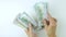 Women's hands count money. Woman's hand recount bundle of dollars