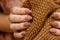 Women& x27;s hands with fashionable manicure with a knitted texture on the background of a knitted scarf or plaid. Actual