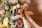 Women`s hands hang ball on Christmas tree