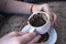 Women`s hands hold cap of turkish coffee, looking fall, fortune