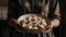 Women\\\'s hands hold a large plate with dumplings, generative AI tools
