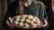 Women\\\'s hands hold a large plate with dumplings, generative AI tools