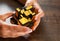 Women`s hands hold mirror magic cube on wooden background