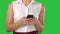 Women`s hands holding cell telephone on a Green Screen, Chroma Key.