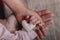 Women`s hands holding the child`s hand with a heart. The concept of motherhood, caring, family, protection, love. Place for text