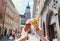 Women`s hands with ice cream on the background of the city sights Mariatsky church in the historical center of Krakow, Poland,