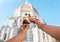 Women`s hands with ice cream Gelato on the background of the city sight Cathedral of Santa Maria del Fiore in the historical