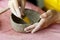Women& x27;s hands knead the clay and sculpt a cup or bowl from it. The process of manufacturing a ceramic product,close
