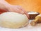 Women\'s hands knead the dough