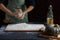 Women`s hands knead the dough. Baking ingredients on wooden table