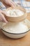 Women\'s hands prepairing flour before baking pie