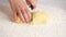 Women`s hands roll out the dough into dumplings, cuts out round pieces of dough with a glass.