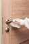 Women`s hands wipe door handle with antibacterial napkin