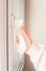 Women`s hands wipe door handle with antibacterial napkin