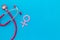 Women`s Health issues. Medical concept with Venus sign and stethoscope on blue background top-down copy space