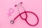 Women`s Health issues. Medical concept with Venus sign and stethoscope on pink background top-down