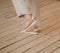 Women`s legs in beige trousers. Dancing, delicate photography.