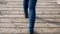 Women`s legs in blue jeans in black autumn shoes