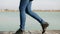 Women`s legs in blue jeans in black autumn shoes