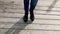 Women`s legs in blue jeans in black autumn shoes