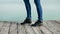 Women`s legs in blue jeans in black autumn shoes
