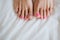 Women`s legs. The damaged nail. Problems with the nails. Painted nails