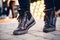 Women`s legs in dark shoes and jeans on street in evening