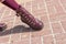 Women`s legs in maroon tights and maroon leather boots with thick soles with high lacing