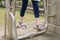 Women\'s legs on an outdoor metal simulator that imitates walking